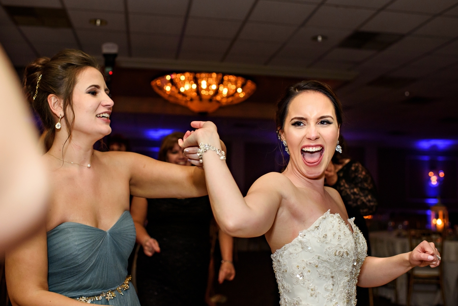 A bride dancing with her bridesmaids at the wedding reception.